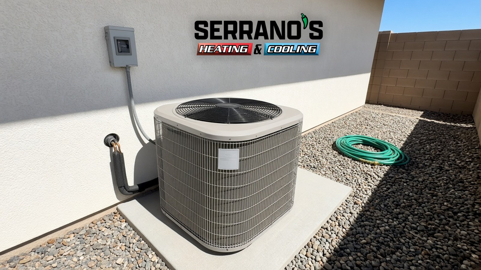 Heat pump outdoor unit on a concrete pad beside a Tucson home, with the line set running into the service valves and the Serrano's Heating & Cooling logo