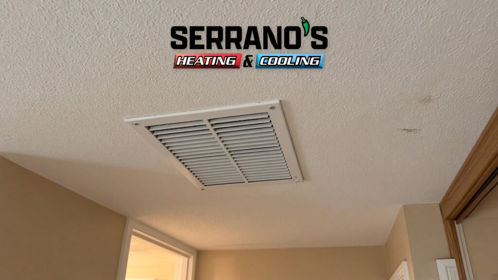 Hallway ceiling air register in a Tucson home on a cool morning with Serrano's Heating & Cooling logo